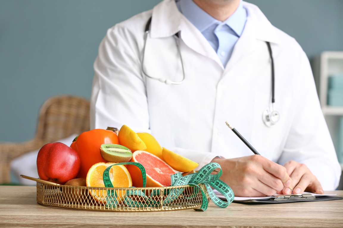 Male Nutritionist Working in His Office